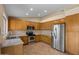 Modern kitchen featuring stainless steel appliances, generous counter space, and oak cabinetry at 1415 W Michigan Ave, Phoenix, AZ 85023