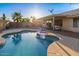 Beautiful backyard featuring a private pool, covered patio, and desert landscaping perfect for outdoor living at 1415 W Michigan Ave, Phoenix, AZ 85023