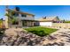 Large backyard with well-manicured artificial lawn, covered patio, and neutral landscaping at 1521 W Jacinto Ave, Mesa, AZ 85202