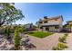 Spacious backyard featuring gravel, artificial turf, mature landscaping, a covered patio, and privacy at 1521 W Jacinto Ave, Mesa, AZ 85202