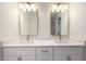Bright bathroom featuring double vanity, quartz counters, modern fixtures, and white cabinets at 1521 W Jacinto Ave, Mesa, AZ 85202