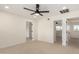 Spacious bedroom with multiple entry points and modern ceiling fan at 1521 W Jacinto Ave, Mesa, AZ 85202