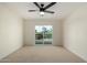 A bedroom with a ceiling fan and sliding glass door to a balcony at 1521 W Jacinto Ave, Mesa, AZ 85202