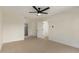 Spacious bedroom with neutral carpet, ceiling fan, a walk-in closet and adjoining bath at 1521 W Jacinto Ave, Mesa, AZ 85202
