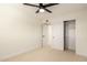 Inviting bedroom with ceiling fan, closet, and doorway highlighting a spacious and functional layout at 1521 W Jacinto Ave, Mesa, AZ 85202