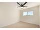 Cozy bedroom features a ceiling fan and a window that offers plenty of natural light at 1521 W Jacinto Ave, Mesa, AZ 85202