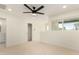 Bright bedroom with ceiling fan, modern trim, large window and a view to the next room at 1521 W Jacinto Ave, Mesa, AZ 85202