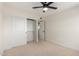 Bright bedroom with fan, closet and doorway showcasing a versatile space to relax and recharge at 1521 W Jacinto Ave, Mesa, AZ 85202