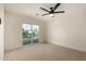 A bedroom with a ceiling fan and sliding glass door to a balcony at 1521 W Jacinto Ave, Mesa, AZ 85202