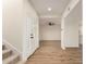 Entryway featuring wood floors, contemporary door, leading to an open-concept living space with a ceiling fan at 1521 W Jacinto Ave, Mesa, AZ 85202