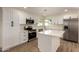 Well lit kitchen with stainless appliances, quartz countertops, island, and white shaker cabinets at 1521 W Jacinto Ave, Mesa, AZ 85202