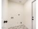 Clean laundry room with decorative tile, utility hook ups, and white walls and trim at 1521 W Jacinto Ave, Mesa, AZ 85202