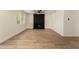 Spacious living room with wood floors, white walls, and a black painted brick fireplace at 1521 W Jacinto Ave, Mesa, AZ 85202