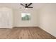 Living room featuring wood floors, white walls, natural light, and a ceiling fan at 1521 W Jacinto Ave, Mesa, AZ 85202