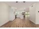 Bright open concept living space and kitchen with hard wood floors and white walls at 1521 W Jacinto Ave, Mesa, AZ 85202