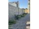 A tranquil side yard with a stone bed features flowers and a block wall for added privacy at 1521 W Jacinto Ave, Mesa, AZ 85202