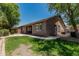 Charming single-story home featuring well-manicured backyard with lush lawn, mature trees and neutral color palette at 162 W Raven Dr, Chandler, AZ 85286