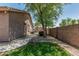 Spacious backyard offers desert landscaping, a small lawn, and a walkway leading to side of the house at 162 W Raven Dr, Chandler, AZ 85286