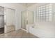 Bright bathroom showcasing a glass-enclosed shower and a soaking tub with natural lighting at 162 W Raven Dr, Chandler, AZ 85286
