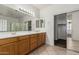 Well-lit bathroom features double sinks and a large mirror and a walk-in closet at 162 W Raven Dr, Chandler, AZ 85286