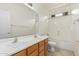 This bathroom features double sinks, a tub with shower, and light-colored walls at 162 W Raven Dr, Chandler, AZ 85286
