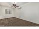 Bedroom with large shuttered windows, ceiling fan, and a sleek wall-mounted air conditioning unit at 162 W Raven Dr, Chandler, AZ 85286