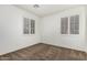 This bedroom features carpeted floors, windows with shutters, and light-colored walls at 162 W Raven Dr, Chandler, AZ 85286
