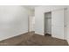 This bedroom features carpeted floors, light-colored walls, a closet, and a doorway at 162 W Raven Dr, Chandler, AZ 85286
