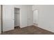 This bedroom features carpeted floors, light-colored walls, and a closet with double doors at 162 W Raven Dr, Chandler, AZ 85286