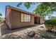 The exterior of this home features a landscaped yard, gravel, and desert foliage at 162 W Raven Dr, Chandler, AZ 85286