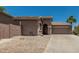 Beige single-story home featuring desert landscaping and a two-car garage at 162 W Raven Dr, Chandler, AZ 85286