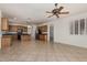 Open kitchen with wood cabinets, black appliances, an island, blending functionality with an open-concept design at 162 W Raven Dr, Chandler, AZ 85286