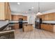 Modern kitchen with wood cabinets, granite countertops, and a central island, perfect for food preparation and dining at 162 W Raven Dr, Chandler, AZ 85286