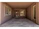 This covered patio features tile flooring, windows with shutters, and access to the backyard at 162 W Raven Dr, Chandler, AZ 85286