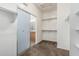 Walk-in closet with an open sliding door and built-in shelving for organized storage at 162 W Raven Dr, Chandler, AZ 85286