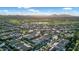 Scenic aerial view of a golf course community, showcasing lush green fairways and well-maintained homes at 1673 E Laddoos Ave, Queen Creek, AZ 85140