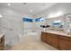 Bright bathroom featuring a shower, soaking tub, and vanity with double sinks and wood cabinets at 1673 E Laddoos Ave, Queen Creek, AZ 85140
