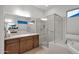 Bathroom featuring a glass enclosed shower, and vanity with sink, cabinets and large mirror at 1673 E Laddoos Ave, Queen Creek, AZ 85140