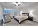 Relaxing bedroom with plantation shutters, ceiling fan, and soft, neutral colors at 1673 E Laddoos Ave, Queen Creek, AZ 85140