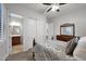Bedroom featuring a queen bed, ceiling fan, and en-suite bathroom with double doors at 1673 E Laddoos Ave, Queen Creek, AZ 85140