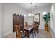Formal dining room featuring a wood table and chairs, chandelier, and patterned screen at 1673 E Laddoos Ave, Queen Creek, AZ 85140
