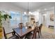 A formal dining room boasts natural light from the windows, and a wooden table at 1673 E Laddoos Ave, Queen Creek, AZ 85140