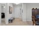 A welcoming entryway with tiled floors, neutral walls, and a bench, leading to a bright white door at 1673 E Laddoos Ave, Queen Creek, AZ 85140