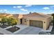 Beautiful single-story home featuring desert landscaping, tile roof, tan stucco, and a two-car garage at 1673 E Laddoos Ave, Queen Creek, AZ 85140