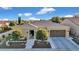 Lovely single-story home with a tile roof, green landscaping, and a two-car garage under a blue sky at 1673 E Laddoos Ave, Queen Creek, AZ 85140