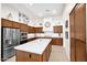 Modern kitchen with stainless steel appliances, wood cabinetry, and white countertops creating a stylish cooking space at 1673 E Laddoos Ave, Queen Creek, AZ 85140