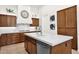 Beautiful kitchen with wood cabinets, a sleek white countertop island, and stainless steel appliances for the home chef at 1673 E Laddoos Ave, Queen Creek, AZ 85140