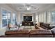 A well-lit living room includes a tray ceiling, modern furnishings, and plantation shutters at 1673 E Laddoos Ave, Queen Creek, AZ 85140