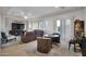 Living room featuring modern furnishings, tray ceiling, and plantation shutters at 1673 E Laddoos Ave, Queen Creek, AZ 85140