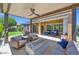 Expansive covered patio featuring a fire pit, dining table, lounge chairs, and a serene atmosphere at 1673 E Laddoos Ave, Queen Creek, AZ 85140